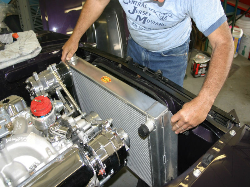 Photo of new radiator being installed in a hot rod.